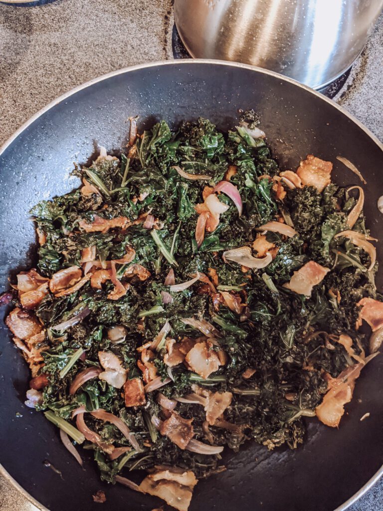 Kale and bacon mixed together in pan